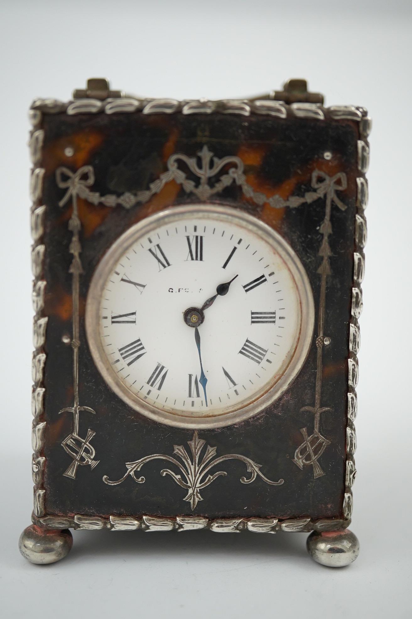 An Edwardian silver mounted tortoiseshell miniature carriage timepiece, by William Comyns